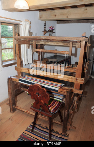Antique loom machine inside old wooden hut, Masuria region in Poland Stock Photo