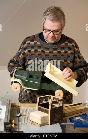 Man making a wooden toy truck Stock Photo - Alamy