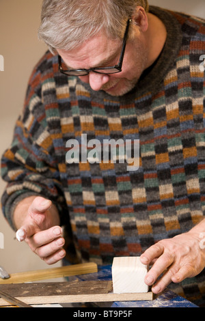 Man making a wooden toy truck. Stock Photo