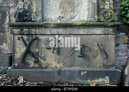 Weathered memorial with various symbols in Old Calton Burial Ground, Edinburgh, Scotland, UK Stock Photo