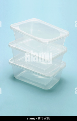 Stack of empty transparent plastic boxes on blue background Stock Photo