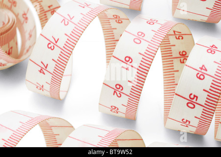 Close up of measuring tapes on white background Stock Photo