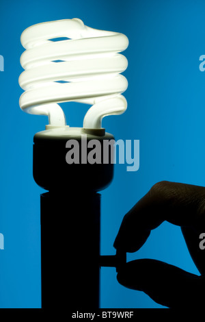 Energy Efficient Fluorescent Light Bulb - Turning On Switch Stock Photo