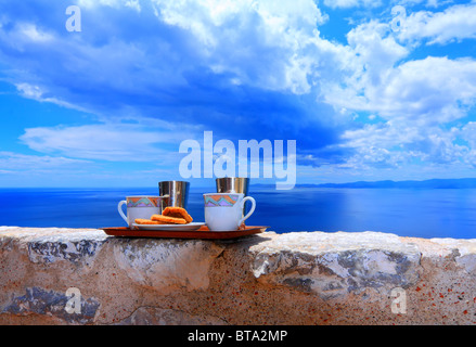 Ready to serve cups of coffee against blue cloudy sky Stock Photo