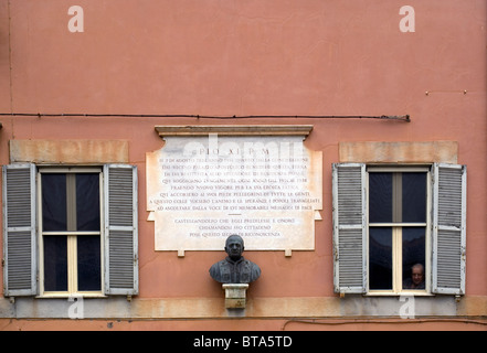 Building facade in Castelgandolfo, with senior man looking through window Stock Photo