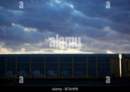 Railway car with dark clouds overhead Stock Photo