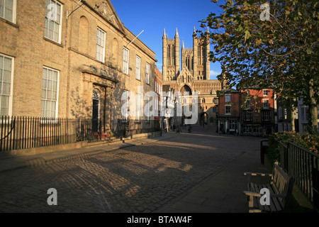 Dramatic west front of Lincoln Cathedral and Exchequer Gate seen from Castle Hill in late afternoon sunshine. Stock Photo