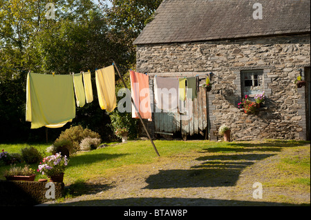 Clothes hanging out to dry on a washing line in a rural cottage garden, UK Stock Photo