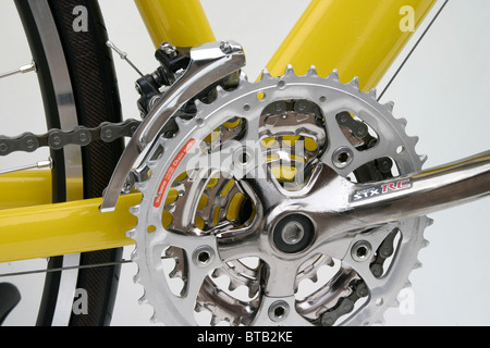 cutout closeup of alloy framed yellow hybrid roadster trekking fitness training style bike with 700c size wheels Stock Photo