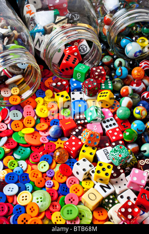 Three jars of buttons, dice and marbles Stock Photo