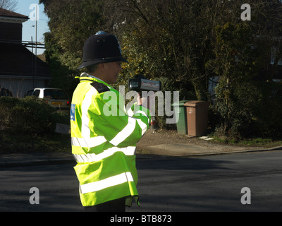 Policeman using speed gun Stock Photo