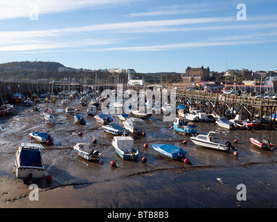 Pleasure craft on the mud at low tide in Scarborough harbour North Yorkshire UK Stock Photo