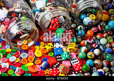 Three jars of buttons, dice and marbles Stock Photo