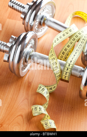 chrome dumbells on wooden floor Stock Photo