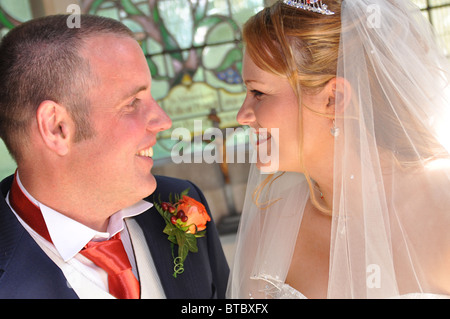 Bride and groom looking at each other smiling Stock Photo