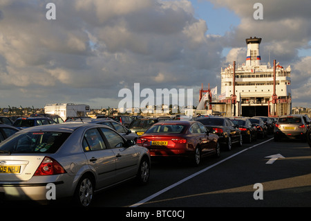 Queuing cars wait in line to board a cross channel ferry at St Malo western France Stock Photo