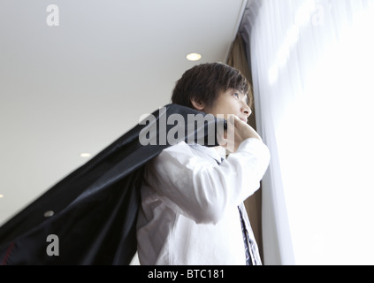 Businessman standing by window Stock Photo