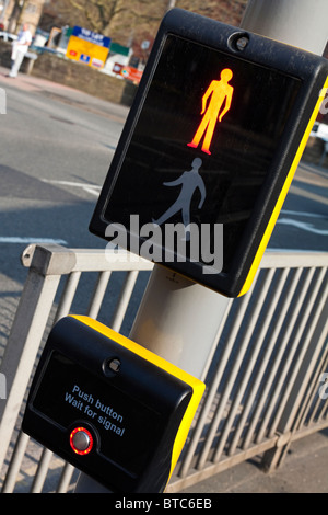 Detail of push button panel on UK Pelican Crossing for pedestrians next to busy road Stock Photo