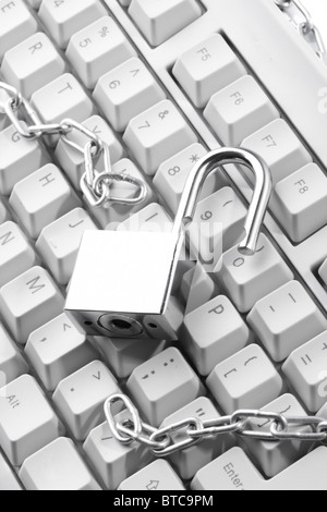 Computer keyboard secured with chain and padlock Stock Photo