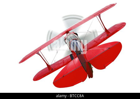 A red biplane, rear view with propeller in motion, isolated on a white background. Stock Photo