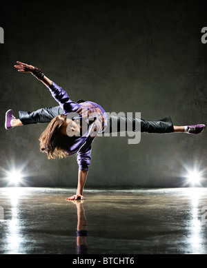 Young woman dancer. On wall background. Stock Photo