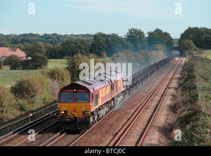 A pair of EWS class 66 locomotives working a train of empty steel wagons at Otford Junction in Kent Stock Photo