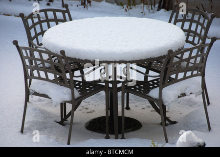 Patio table and chairs in deep snow Stock Photo