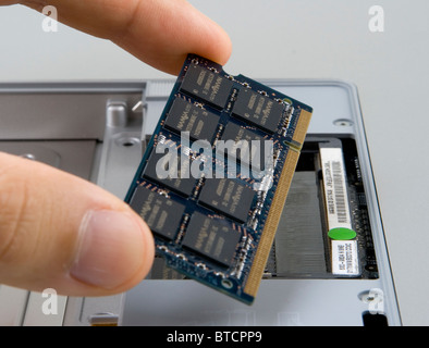 Adding, removing or replacing random access memory (RAM) in a notebook computer Stock Photo