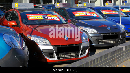 Ilford East London Renault used second hand car dealership forecourt display row in line of dealer cars with clearance sale price tag label England UK Stock Photo