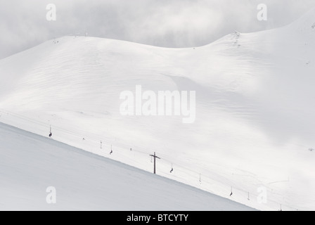 winter sports background with snow and ski-lift on mountains Stock Photo