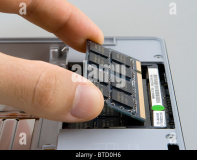 Adding, removing or replacing random access memory (RAM) in a notebook computer Stock Photo