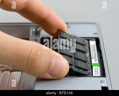 Adding, removing or replacing random access memory (RAM) in a notebook computer Stock Photo