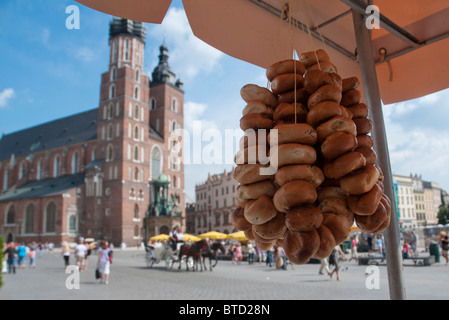 view of polish local bread stall in Krakow old market city center in Poland Europe with St Mary's Basilica in background Stock Photo