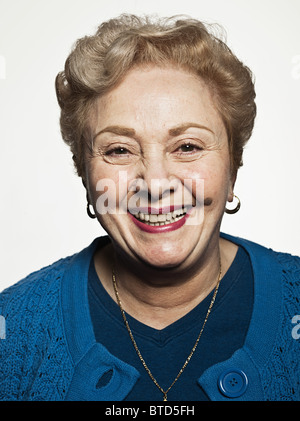 Stuido portrait of cheerful senior woman Stock Photo