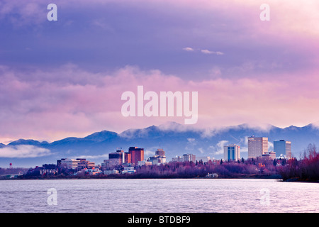 Skyline view of the sun rising over a fog shrouded Anchorage and Cook Inlet, Southcentral Alaska, Fall