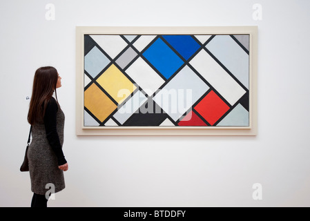 Woman looking at painting Countercomposition XVI by Theo van Doesburg at Gemeentemuseum in The Hague, Den Haag, Netherlands Stock Photo