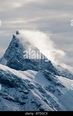 Fresh snow blows from the summit of Mount Doonerak in in Gates of the Arctic National Park and Preserve, Arctic Alaska, Summer Stock Photo