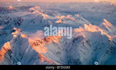 Aerial view of the Chugach Mountain range with sunrise alpenglow hitting the peaks during Winter in Southcentral Alaska Stock Photo