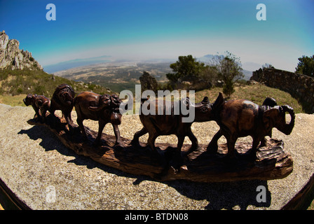 Fish-eye view of wooden carvings for sale at the roadside Stock Photo