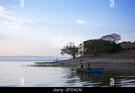 Scenic view of Lake Awassa with fishermen fishing with a net from a blue boat Stock Photo
