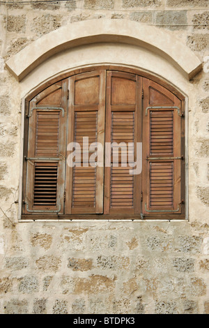 Wooden window shutters on an arched window Stock Photo