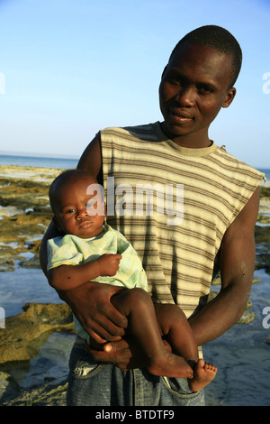 Black man holding a baby Stock Photo