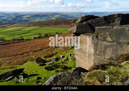 Abandoned millstones and Stanage Edge in the Peak District, Derbyshire, England Stock Photo