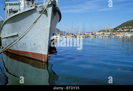 Fishing trawler in Hout bay harbour with large number of boats and yachts moored in the background Stock Photo