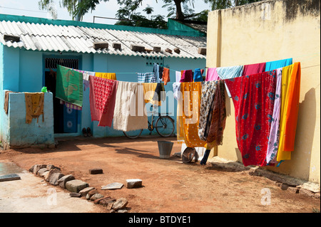 Colourful clothes on a washing line outside a rural indian home Stock Photo