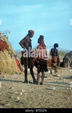 A Himba man and woman conversing at their homestead Stock Photo