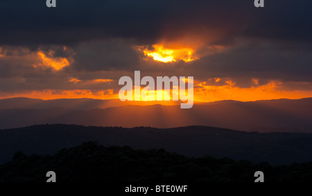 Rays of sun shining through dark clouds, Andalucia, Spain Stock Photo