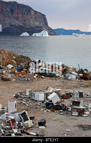 Rubbish at garbage dump and icebergs at the fishing village Uummannaq ...