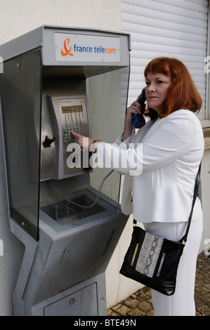 Woman using a France Telecom public callbox Stock Photo