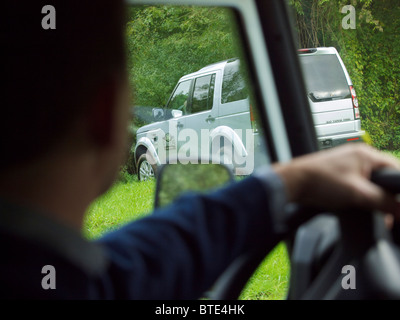 Driver's view of Land Rover Discovery 4 driving through green terrain at the Domaine d'Arthey estate in Belgium Stock Photo